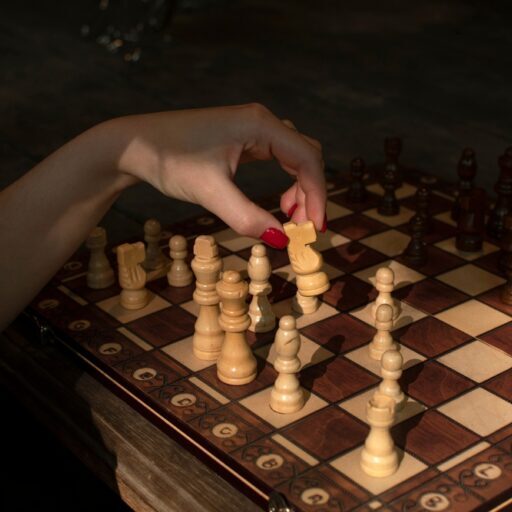 Woman,Is,Moving,Chess,Pieces,On,Chess,Board